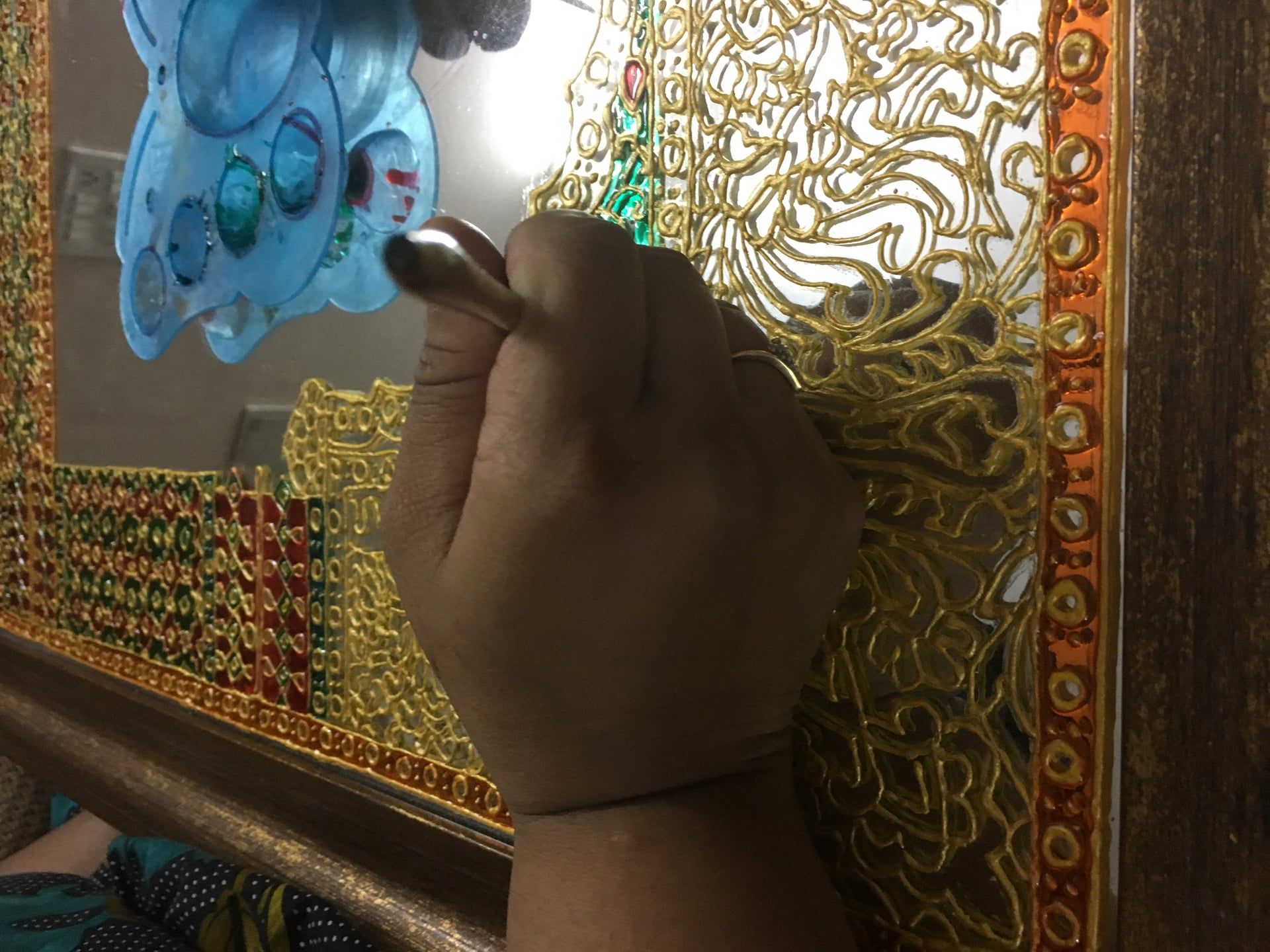 Artist hands - intricate Thikri mirror painting process